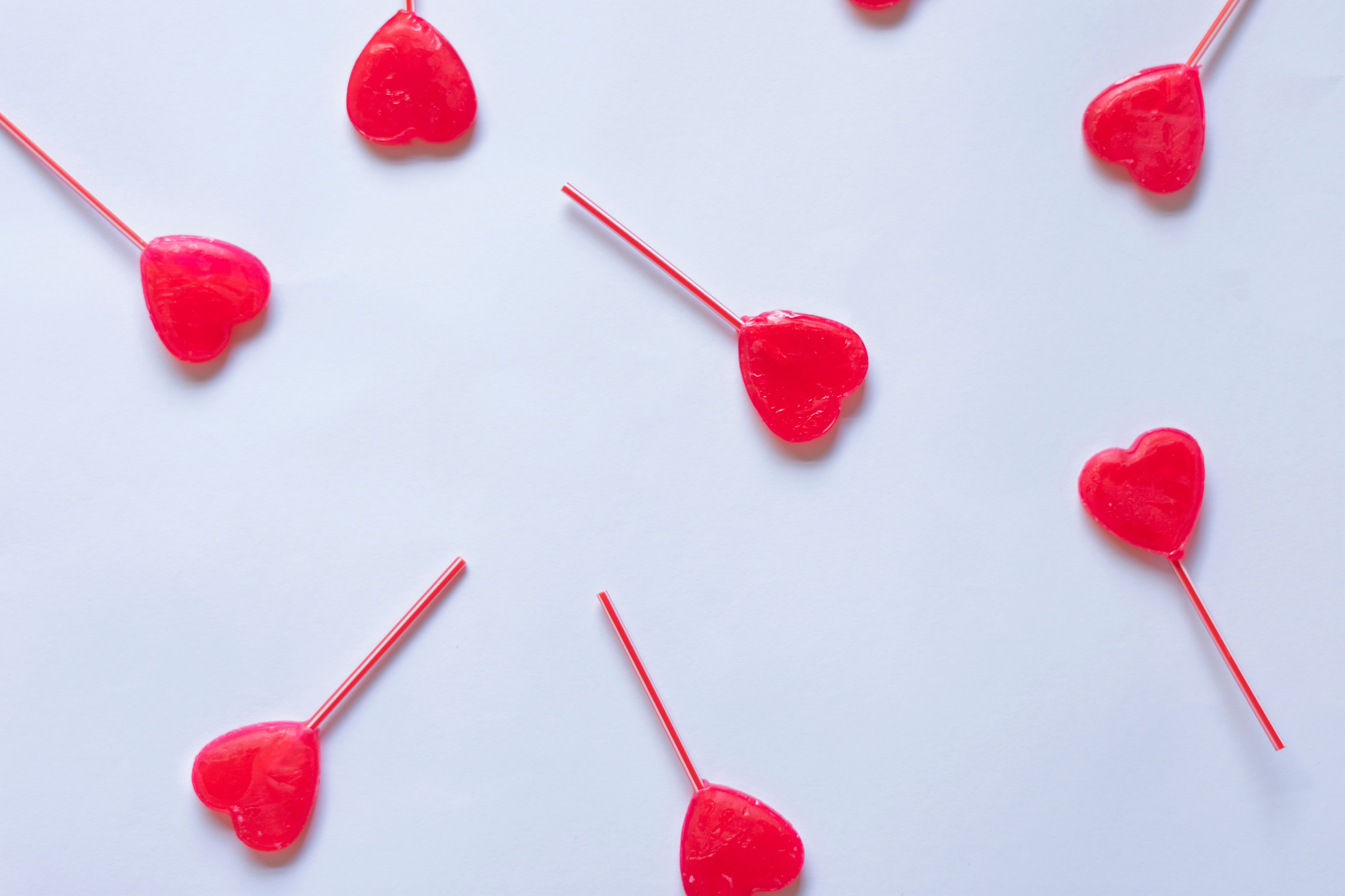 valentine's background, with heart-shaped lollipops distributed on a white background with basic space for text
